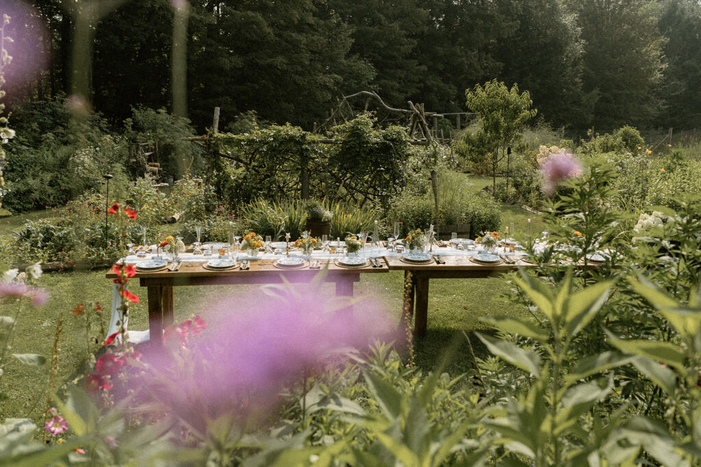 Garden reception table surrounded by summer flowers at one of Vermont’s most charming intimate wedding locations.