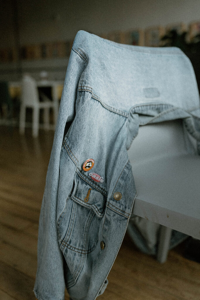 Light denim jacket draped over a chair in a cozy home, a simple styling detail often included in relaxed family photo outfits.