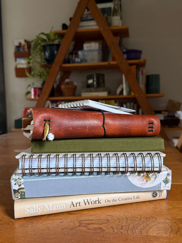stack of notebooks, planners, and journals for a more analog life