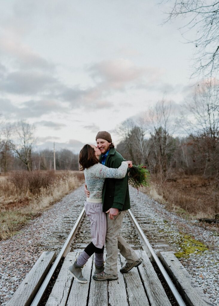 People dancing on train tracks during their intimate Vermont elopement