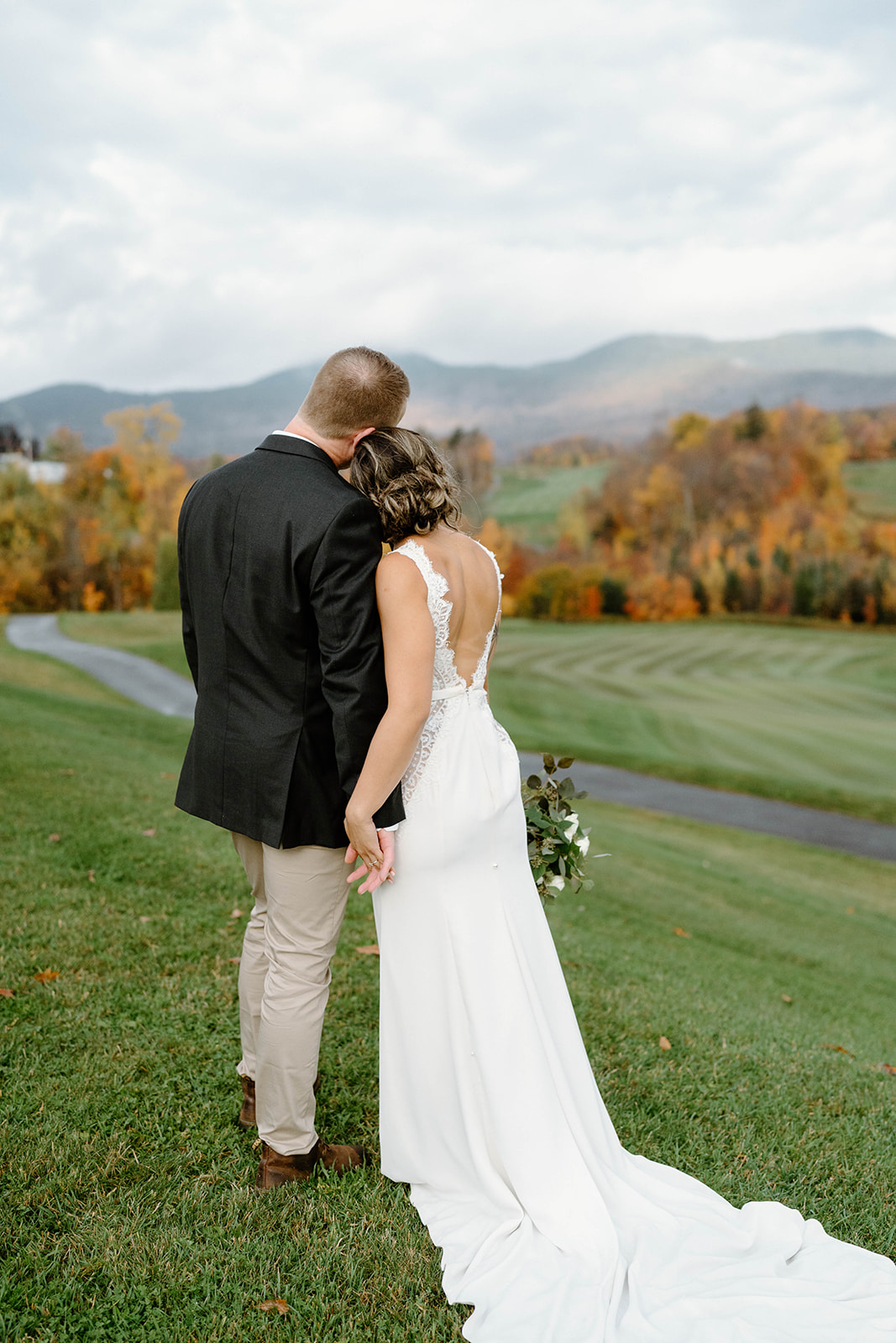 bride and groom looking at scenic fall views at Jay Peak Resort in Jay Vermont