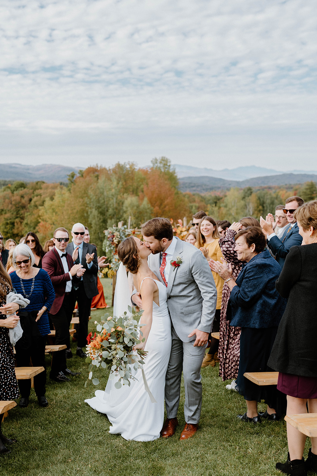 bride and groom kissing after elopement ceremony at at Bliss Ridge Farm in Moretown, Vermont