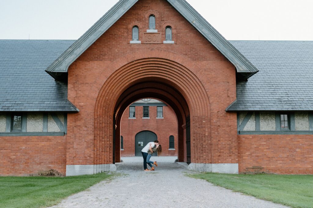 Shelburne Farms photo locations — engagement photo under Coach Barn arches