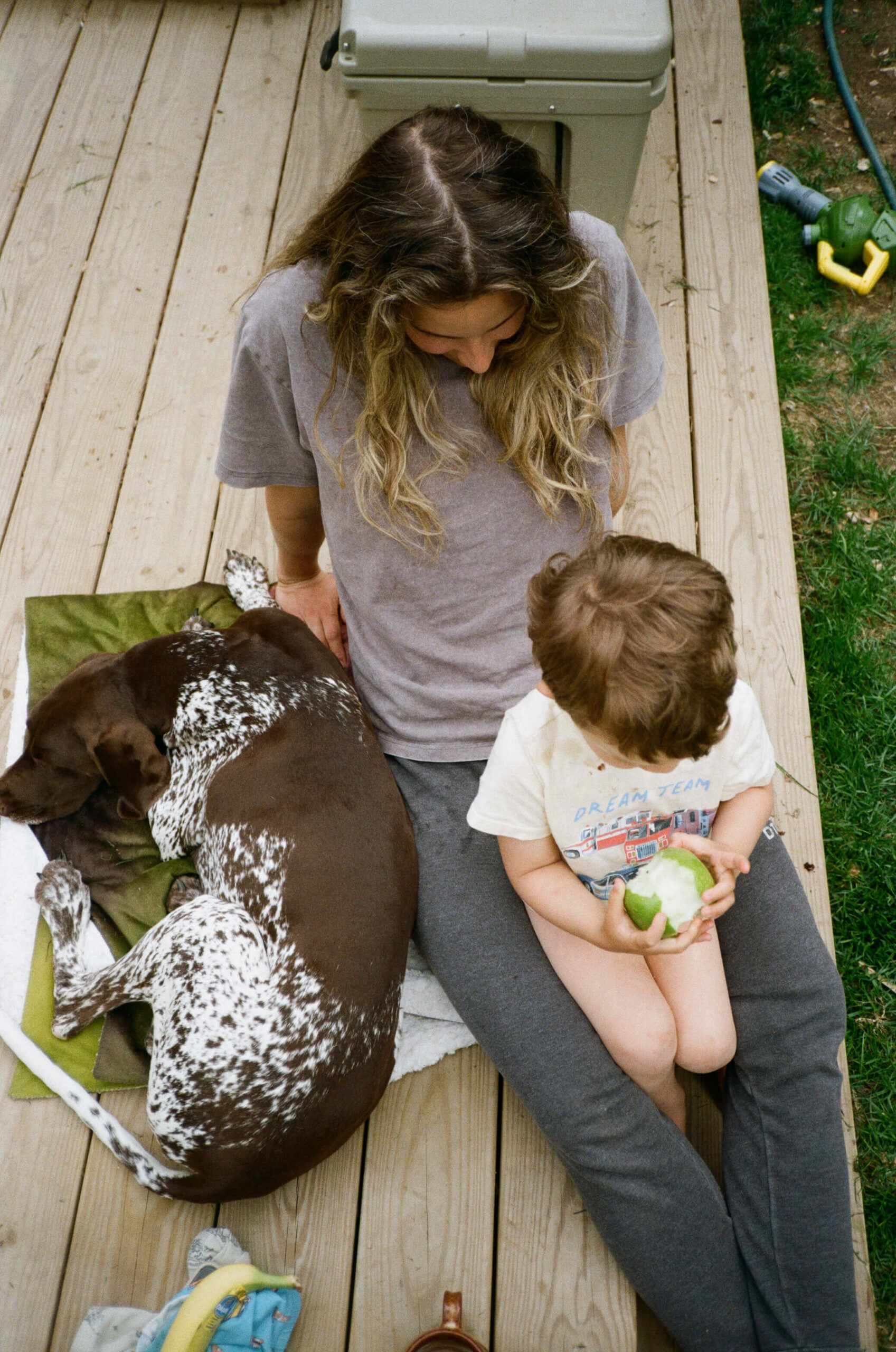 mom enjoying time with dog and son